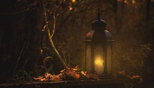 yellow pillar candle in black lantern