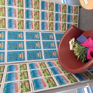 speaker's chair in front of wall of book covers