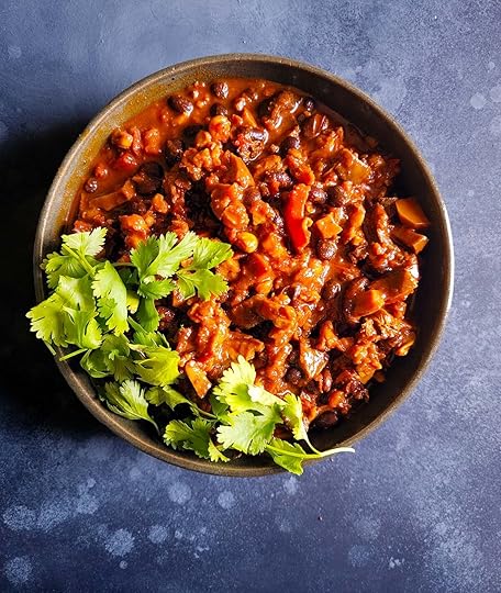A bowl of mushroom chili with cilantro garnish.