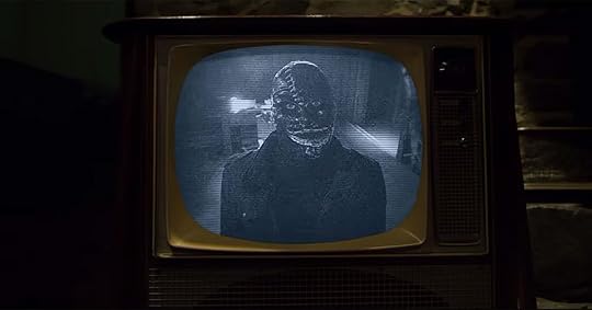 image of a killer in blackface mask on tv in horror movie the blackening