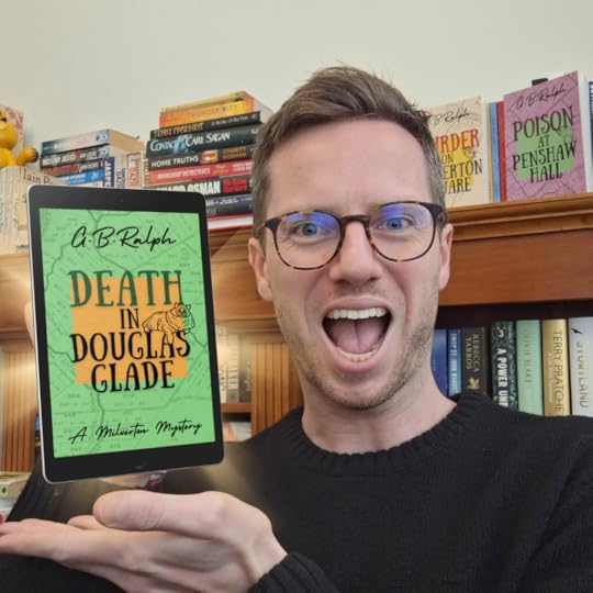 Death in Douglas Glade by G B Ralph. Author selfie with glowing tablet showing book cover design.