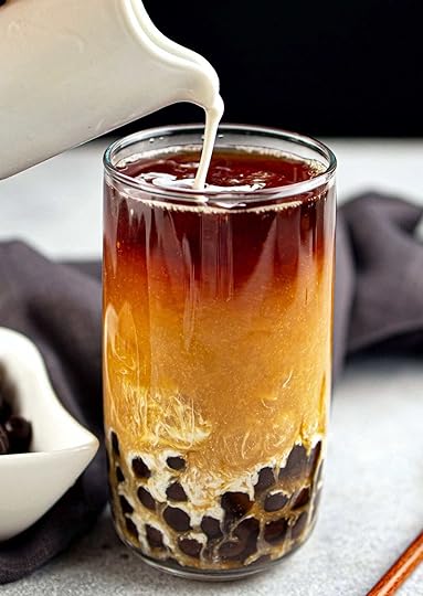 pouring milk into boba milk tea