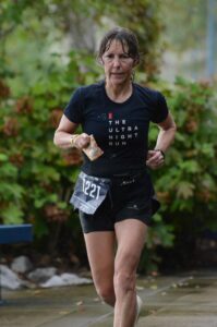 Female runner running in the rain in shorts and t-shirt