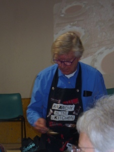 Robin Ellis cooking demonstration at the Parisot Literary Festival in Sex Pistols apron
