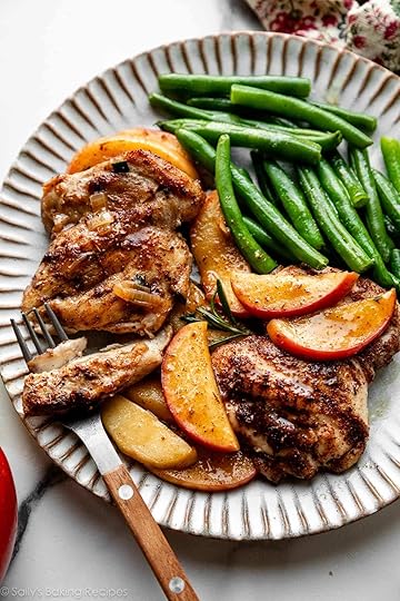 apple cider chicken and apple slices with green beans on plate.