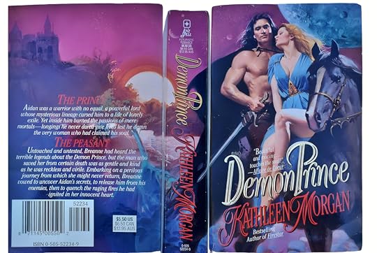 Image of a romance novel cover, titled 'Demon Prince' by Kathleen Morgan. The front cover features a muscular man with long, flowing hair, holding a sword, sitting on a horse, beside a blonde woman in a flowing blue dress. There are stars and a large moon in the background. The spine and back cover show a pinkish-purple color theme with text describing the plot. A mystical castle under a twilight sky is depicted in the background.
