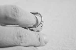 Fingers holding wedding ring