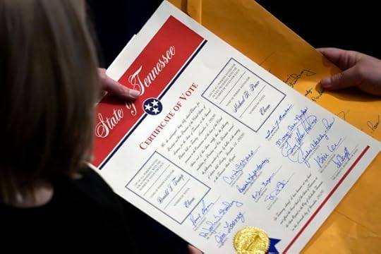 Staff members hold the certification of Electoral College votes from Tennessee during a joint session of the House and Senate to confirm Electoral College votes at the Capitol, early Jan 7, 2021, in Washington.