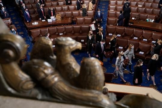 Senate pages carry boxes containing Electoral College votes into a joint session of the House and Senate convenes to count the electoral votes cast in November's election, at the Capitol.
