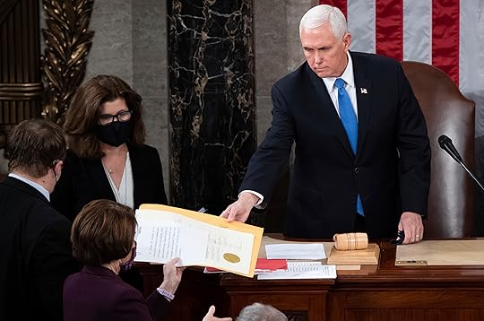 FILE – Vice President Mike Pence hands the electoral certificate...