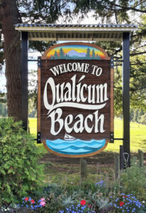 Brown wooden sign with vintage lettering in white reads: 