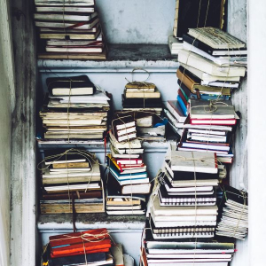 piles of notebooks in a closet. 