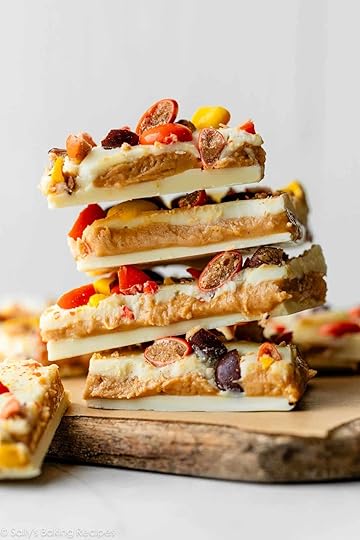 stack of white chocolate and peanut butter bark with Reese's Pieces candies on top.