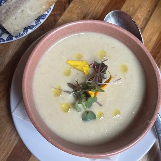 roasted cauliflower soup in a brown bowl