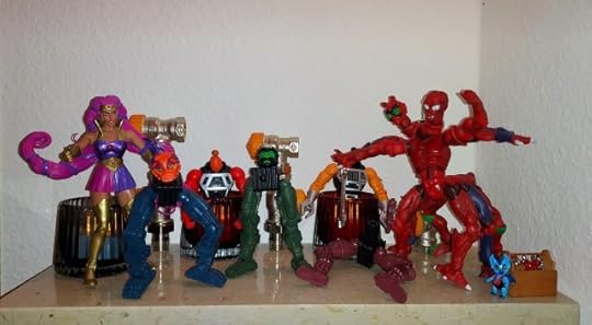 Entrapta has put the two Multi-Bot heads on the legs and pelvis pieces, much to Modulok's frustration, while Imp looks on.