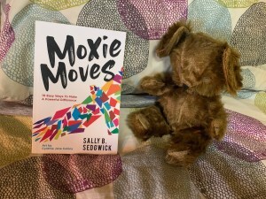 Book (Moxie Moves) and Bear on bed