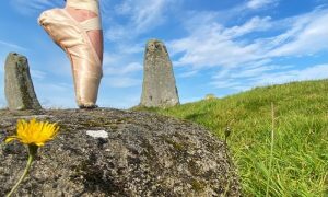 Ailish Sinclair dances in a stone circle.
