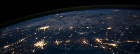 Earth’s curvature with city lights visible from space at night.
