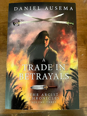 A Trade in Betrayals cover art, woman surrounded by flames