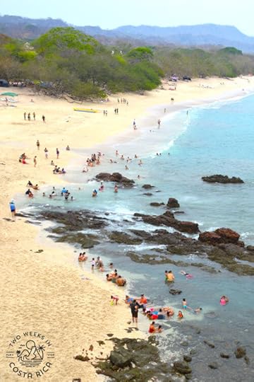 white sand beach with turquoise water and rocks