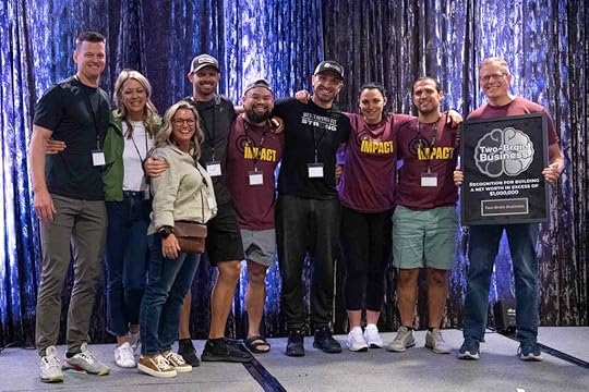 Eric Conner, fourth from the left, poses with Chris Cooper and other newly minted millionaires at the 2022 Two-Brain Summit.