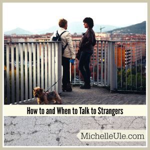 Two women talking to each other with a dog