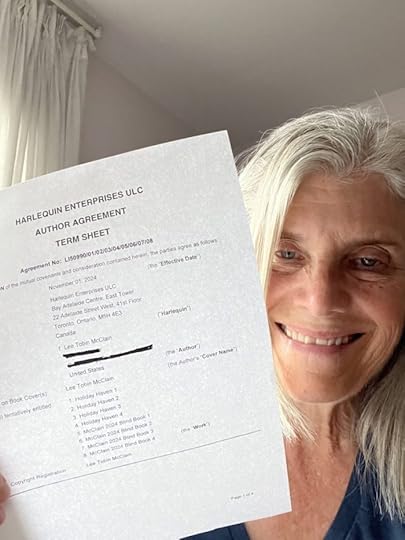 author holding up book contract