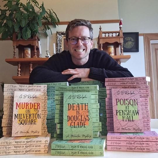 Author G B Ralph with stacks of Milverton Mysteries paperbacks.