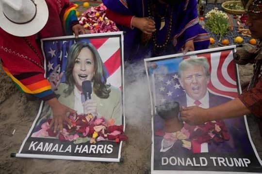 Shamans perform a good luck ritual holding posters of Democratic presidential nominee Vice President Kamala Harris and Republican presidential nominee former President Donald Trump