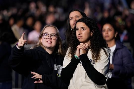 Supporters of Democratic presidential nominee Vice President Kamala Harris look at election results during an election night campaign watch party