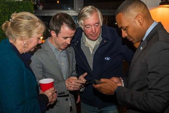 Monterey City Council candidate Eric Palmer (second from left) looks at results with supporters and Monterey Mayor Tyller Williamson (far right) during an election night party in Monterey, on Tuesday. (Nic Coury -- Herald Correspondent)
