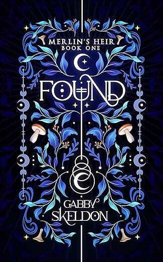 The cover design for 'Found, Merlin's Heir Book One'. The title text is a thin white font, with a vertical line connecting it to a crescent moon, and to the author's name. The white text is surrounded by symmetrical blue illustrations of forest, leave and mushroom motifs. 