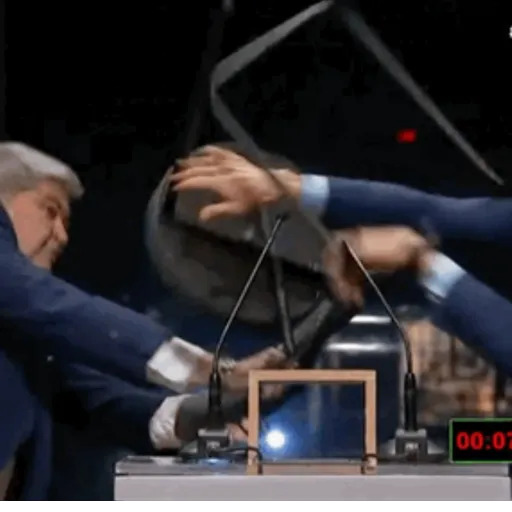 Live footage of a debate between mayoral candidates in São Paulo. Candidate Pablo Marçal is speaking into a microphone while looking at the camera when he's hit by another candidate with a metal chair.