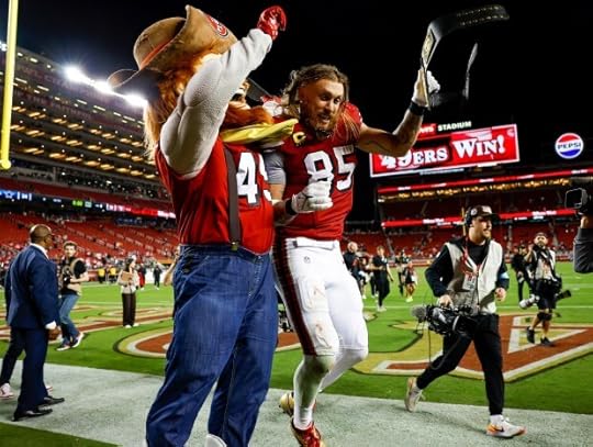 San Francisco 49ers' George Kittle (85) celebrates with 49ers mascot Sourdough Sam after they beat the Dallas Cowboys 30-24 at Levi's Stadium in Santa Clara, Calif., on Sunday, Oct. 27, 2024. (Nhat V. Meyer/Bay Area News Group)