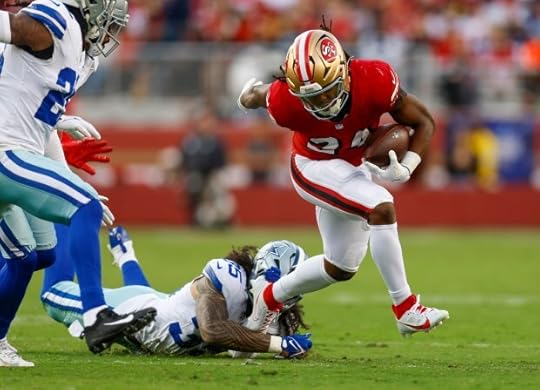 San Francisco 49ers' Jordan Mason (24) runs against Dallas Cowboys' Marist Liufau (35) in the first quarter at Levi's Stadium in Santa Clara, Calif., on Sunday, Oct. 27, 2024. (Nhat V. Meyer/Bay Area News Group)