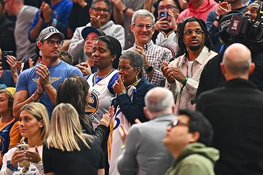 Basketball fans stand and pay their respects for the family...