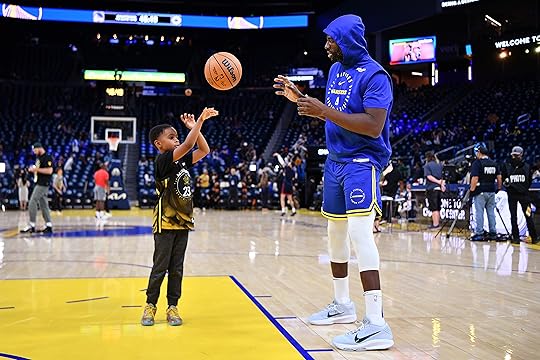 Draymond Green Jr. throws a ball to his father Golden...