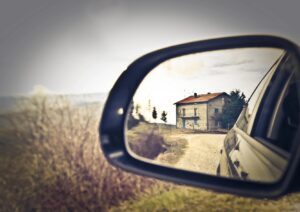 Reflection of home in rearview mirror