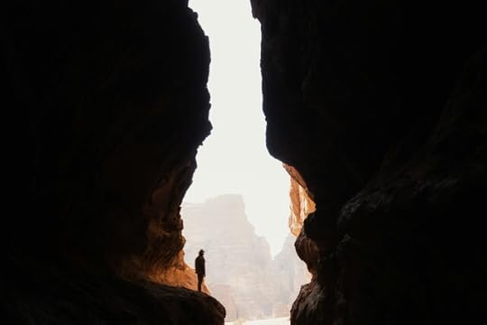 Person standing on a ledge in a narrow valley - choices, decisions, and your life today