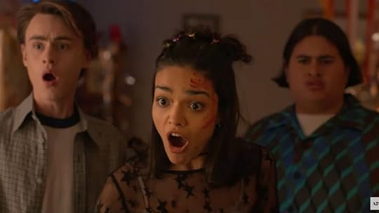 three teens stand together with mouths open in shock in y2k trailer