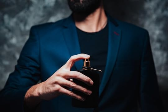 man holding luxury men's fragrance