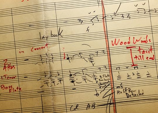 A close up of several bars of handwritten musical notation with instructions to musicians such as 