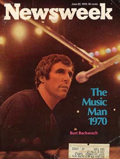 Newsweek cover, a medium shot of Burt Bacharach before a microphone on stage, with bright multicolored lights overhead.