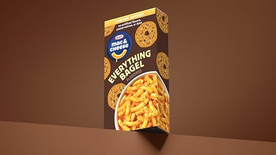 A brown box of Kraft Mac & Cheese Everything Bagel on a brown pedestal against a brown bacground it's all very, very brown and also there's some orange cause of the cheese