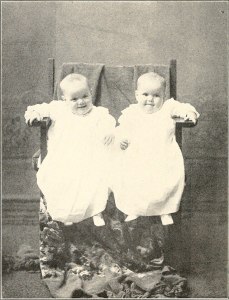 Old photo of twins in a rocking chair