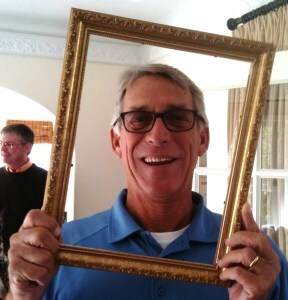 Man holding up a picture frame