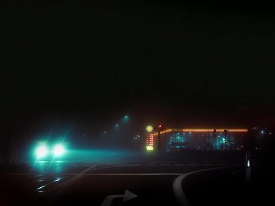 Current image: a car on a dark road near gas station