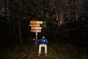 I sit next to a sign pointing in the direction of my home town, Bad Nenndorf.