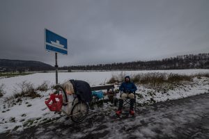 I sit, having lunch, next to a sign for ships on the river Weser.