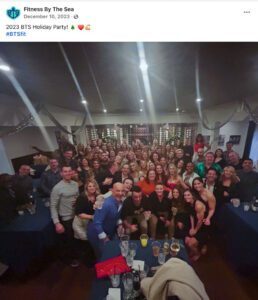 A large group photo from a party hosted by the gym Fitness by the Sea.